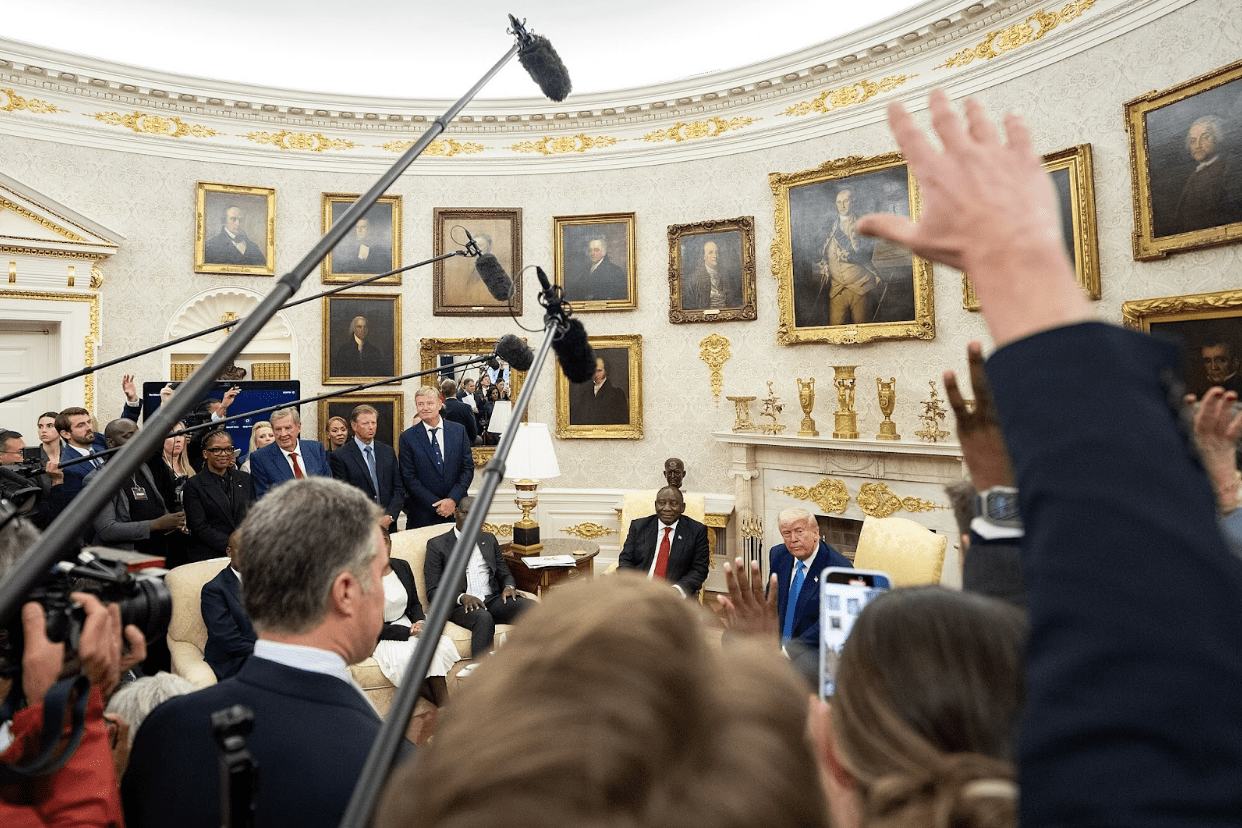 U.S. President Donald Trump receives questions from reporters holding microphones at him and South African President Cyril Ramaphosa during a meeting in the Oval Office at the White House on May 21, 2025. Photo by Emily J. Higgins / The White House (public domain), via Wikimedia Commons
